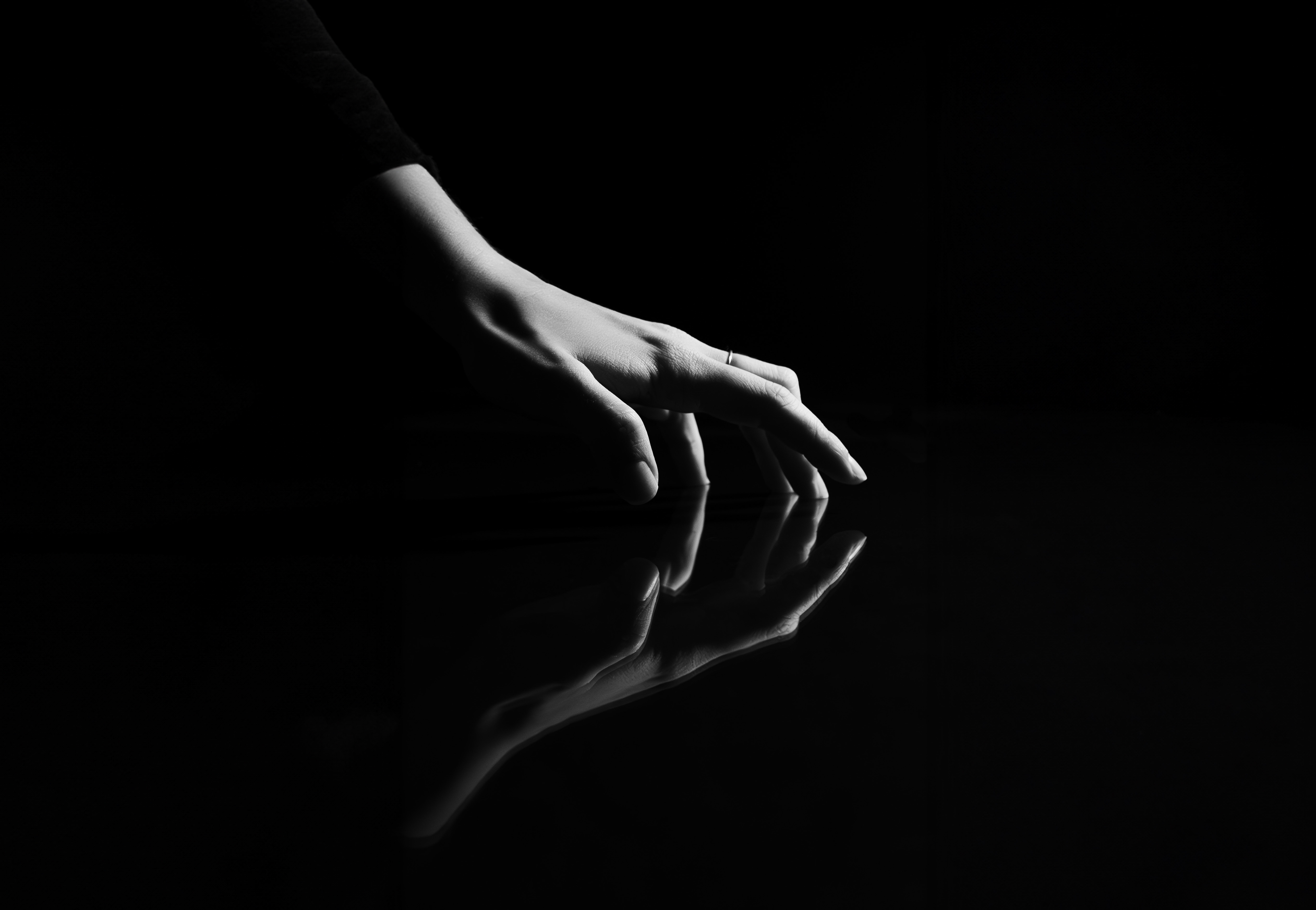 Woman holding mirror under sky